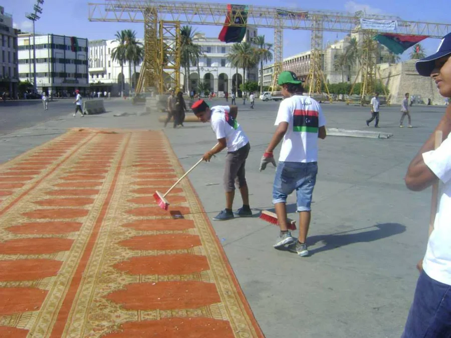 متطوعون ينظّفون أرضية ساحة الشهداء في طرابلس